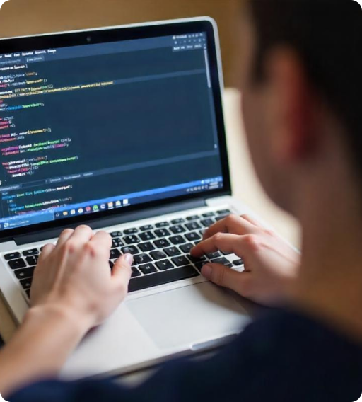 A medical software developer works on code displayed on a laptop screen, highlighting the role of developers in creating advanced healthcare solutions.